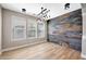 Stylish living room with wood-look floors, unique light fixture, and a captivating accent wall at 21134 W Green St, Buckeye, AZ 85396