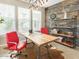Stylish home office featuring rustic wood paneling, modern desk, bright lighting, and neutral flooring at 21134 W Green St, Buckeye, AZ 85396