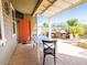 Inviting covered patio with outdoor dining table, tv, built-in grill, and bar area at 21134 W Green St, Buckeye, AZ 85396
