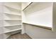 A well-organized walk-in closet with multiple wooden hanging rods and wire shelves at 21134 W Green St, Buckeye, AZ 85396