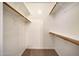 A bright, walk-in closet with wooden hanging rods and wire shelving at 21134 W Green St, Buckeye, AZ 85396