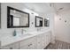 Bathroom featuring dual vanities, framed mirrors, and decorative tile flooring at 2170 E Alameda Dr, Tempe, AZ 85282