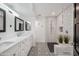 Well-lit bathroom features dual vanities, stylish tile flooring and walk-in shower at 2170 E Alameda Dr, Tempe, AZ 85282