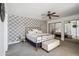 Spacious bedroom featuring patterned wallpaper, ceiling fan and sliding mirror door closet at 2170 E Alameda Dr, Tempe, AZ 85282