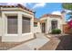 Close-up of exterior elevation featuring a modern front door with a festive wreath, and desert landscaping at 2170 E Alameda Dr, Tempe, AZ 85282