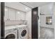 Bright laundry room featuring a modern washer and dryer set, white cabinets, and easy access to the rest of the home at 2170 E Alameda Dr, Tempe, AZ 85282