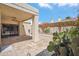 A spacious covered patio with stylish tile flooring offers access to the home and a garden featuring mature cactus plants at 2170 E Alameda Dr, Tempe, AZ 85282