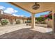 Inviting covered patio has travertine tile flooring and views of well maintained landscaping with cacti and flowering vines at 2170 E Alameda Dr, Tempe, AZ 85282
