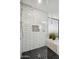 Shower featuring black hexagon tiling, sleek subway tile, and a built-in toiletry niche at 2170 E Alameda Dr, Tempe, AZ 85282