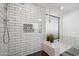 Walk-in shower featuring black hexagon tile and white subway tile with built in toiletry niche at 2170 E Alameda Dr, Tempe, AZ 85282
