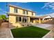 Backyard with artificial turf, pavers, gravel, mature landscape, and a covered patio at 21972 N 97Th Gln, Peoria, AZ 85383