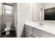 Bright bathroom featuring a white vanity with a gold faucet and black hardware at 21972 N 97Th Gln, Peoria, AZ 85383