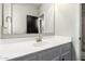 A bright bathroom vanity featuring a sleek sink, modern faucet, and large mirror at 21972 N 97Th Gln, Peoria, AZ 85383