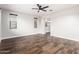 Spacious bedroom with wood-look tile flooring, ceiling fan, and natural light at 21972 N 97Th Gln, Peoria, AZ 85383