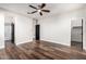 Bright bedroom featuring a ceiling fan, vinyl floors, and access to the bathroom at 21972 N 97Th Gln, Peoria, AZ 85383