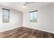A bright bedroom with two windows and luxury vinyl plank flooring at 21972 N 97Th Gln, Peoria, AZ 85383