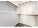 A large walk-in closet with multiple wooden rods for hanging clothes at 21972 N 97Th Gln, Peoria, AZ 85383