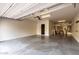 Spacious garage with epoxy floor, shelving, and high ceilings, ready for customization at 21972 N 97Th Gln, Peoria, AZ 85383