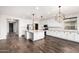 Open concept kitchen with a center island, white cabinets, granite countertops, and stainless-steel appliances at 21972 N 97Th Gln, Peoria, AZ 85383