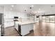 Modern kitchen featuring white cabinets, granite countertops, tile backsplash, and stainless-steel appliances at 21972 N 97Th Gln, Peoria, AZ 85383