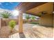 Paver patio featuring a covered porch, string lights, artificial turf, and a block wall at 21972 N 97Th Gln, Peoria, AZ 85383