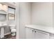 Practical powder room with pedestal sink, toilet, and cabinet with storage at 21972 N 97Th Gln, Peoria, AZ 85383