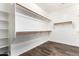 Open walk-in closet with custom shelving and ample storage space at 21972 N 97Th Gln, Peoria, AZ 85383