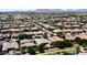 Expansive aerial view of a suburban neighborhood with mountain views, showcasing numerous single-Gathering homes and tree-lined streets at 22290 E Escalante Rd, Queen Creek, AZ 85142