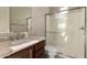 Bathroom featuring granite countertops, a shower with glass door, and vanity at 22290 E Escalante Rd, Queen Creek, AZ 85142