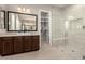 Spa-like bathroom with a glass-enclosed shower, a modern vanity, and a view to the walk-in closet at 22290 E Escalante Rd, Queen Creek, AZ 85142