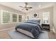 Comfortable bedroom featuring large windows, a ceiling fan, and neutral decor at 22290 E Escalante Rd, Queen Creek, AZ 85142