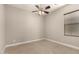 Simple bedroom with neutral walls and ceiling fan and a window with blinds at 22290 E Escalante Rd, Queen Creek, AZ 85142