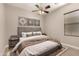 Cozy bedroom with a ceiling fan, warm neutral decor, and decorative artwork at 22290 E Escalante Rd, Queen Creek, AZ 85142