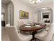 Formal dining room boasts a decorative table, cushioned chairs, and seamless transition to other areas at 22290 E Escalante Rd, Queen Creek, AZ 85142