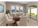 Inviting dining area with a modern table, comfortable seating, and plenty of natural light from shuttered windows at 22290 E Escalante Rd, Queen Creek, AZ 85142