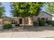 Charming single-story home with stone accents, lush landscaping, and a well-manicured front yard at 22290 E Escalante Rd, Queen Creek, AZ 85142
