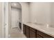 Hallway with dark cabinets topped with light countertops offers generous storage and leads to the exterior door at 22290 E Escalante Rd, Queen Creek, AZ 85142