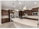 Beautiful kitchen with stainless appliances, granite countertops, pendant lights, and custom cabinetry at 22290 E Escalante Rd, Queen Creek, AZ 85142