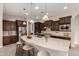 Bright kitchen featuring a spacious island with barstool seating, pendant lighting, and stainless steel appliances at 22290 E Escalante Rd, Queen Creek, AZ 85142