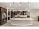 Gourmet kitchen features a large center island, stainless steel appliances, and a breakfast bar at 22290 E Escalante Rd, Queen Creek, AZ 85142