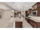 Open-concept kitchen featuring granite counters, stainless steel appliances, and seamless flow into the living spaces at 22290 E Escalante Rd, Queen Creek, AZ 85142