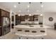 Bright kitchen featuring a spacious island with barstool seating, pendant lighting, and stainless steel appliances at 22290 E Escalante Rd, Queen Creek, AZ 85142