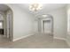 Spacious open-concept living room with modern lighting, archways, and smooth flooring at 22290 E Escalante Rd, Queen Creek, AZ 85142