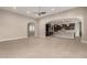 Open living space featuring tile floors, neutral decor, and seamless transition to kitchen area at 22290 E Escalante Rd, Queen Creek, AZ 85142