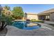 Beautiful pool with tile surround, grass, and plenty of privacy from mature landscaping at 22290 E Escalante Rd, Queen Creek, AZ 85142
