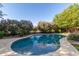 Inviting pool features lush flowering bushes and nearby trees for relaxing outdoor enjoyment at 22290 E Escalante Rd, Queen Creek, AZ 85142