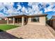 Large backyard with covered patio, synthetic grass, and brick pavers, perfect for outdoor living at 23195 S 226Th Way, Queen Creek, AZ 85142