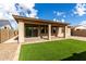 This backyard has a covered patio and synthetic lawn at 23195 S 226Th Way, Queen Creek, AZ 85142