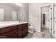 The bathroom boasts wood cabinets, a white countertop, and tile flooring with a view to the hall at 23195 S 226Th Way, Queen Creek, AZ 85142