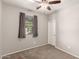 This bedroom features neutral walls, carpet flooring, and a ceiling fan for added comfort at 23195 S 226Th Way, Queen Creek, AZ 85142